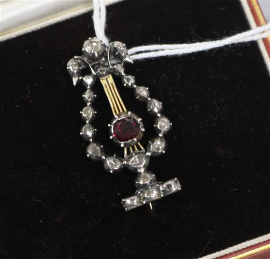 A late Victorian gold and silver, rose cut diamond and garnet set lyre brooch, in later fitted box, 34mm.